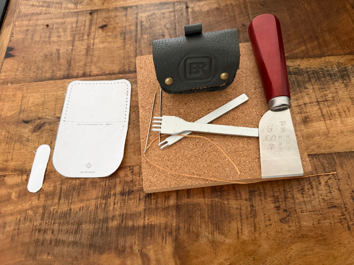 Leren AirPods hoesje naast het gereedschap waarmee het met de hand is gemaakt