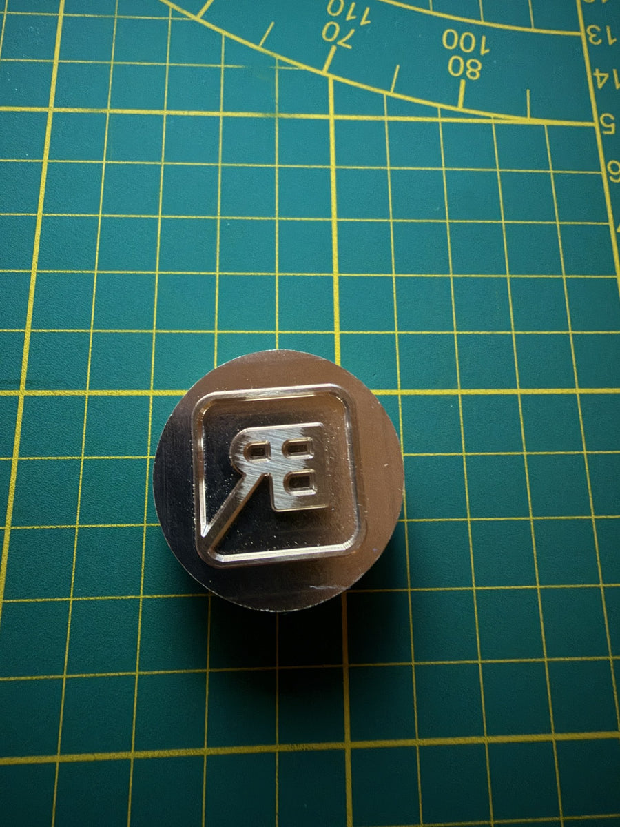 De messing stempel waarmee B-Roffa het BR-logo in het leer zet